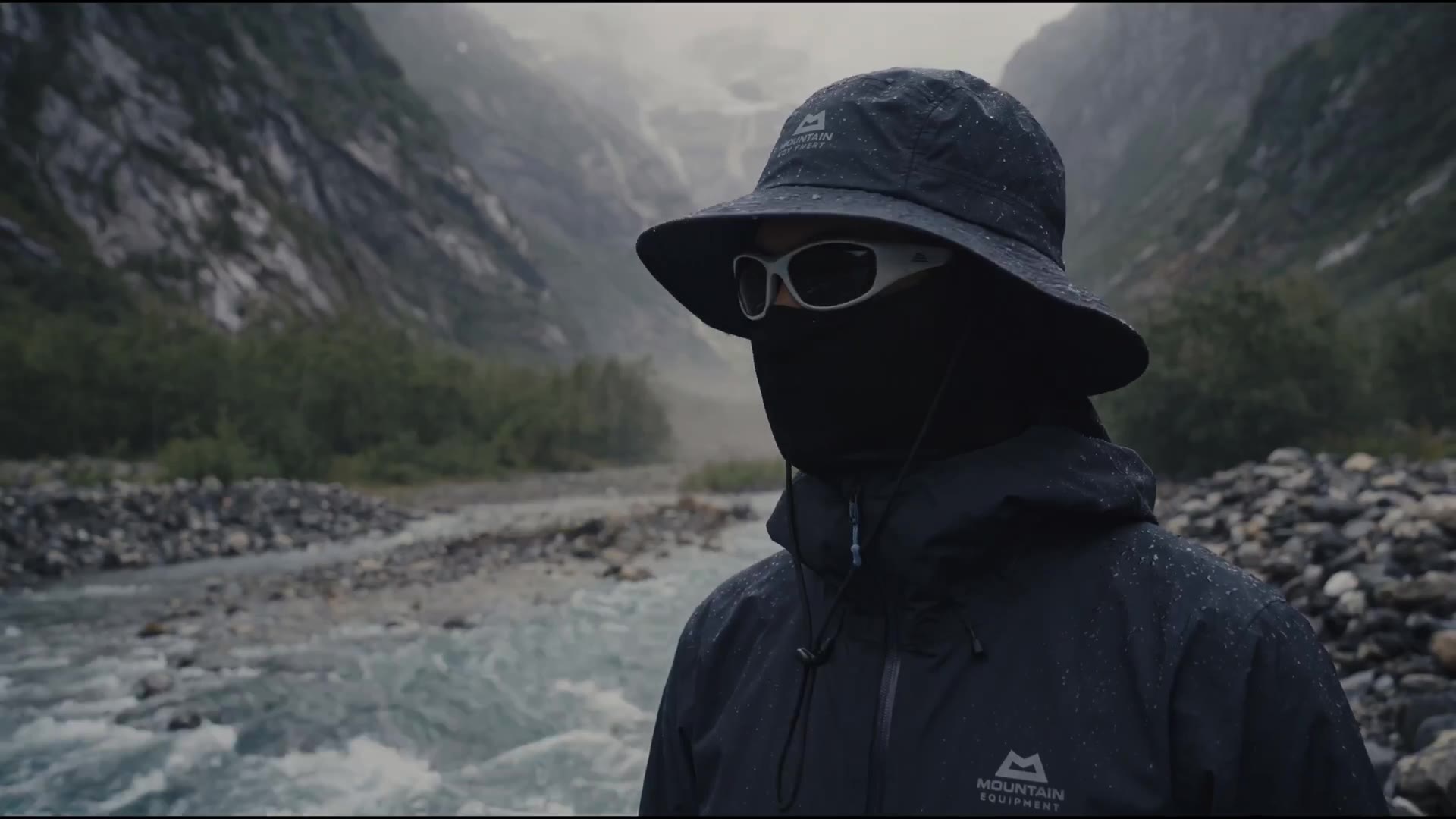 Model in technical outerwear by a glacial river
